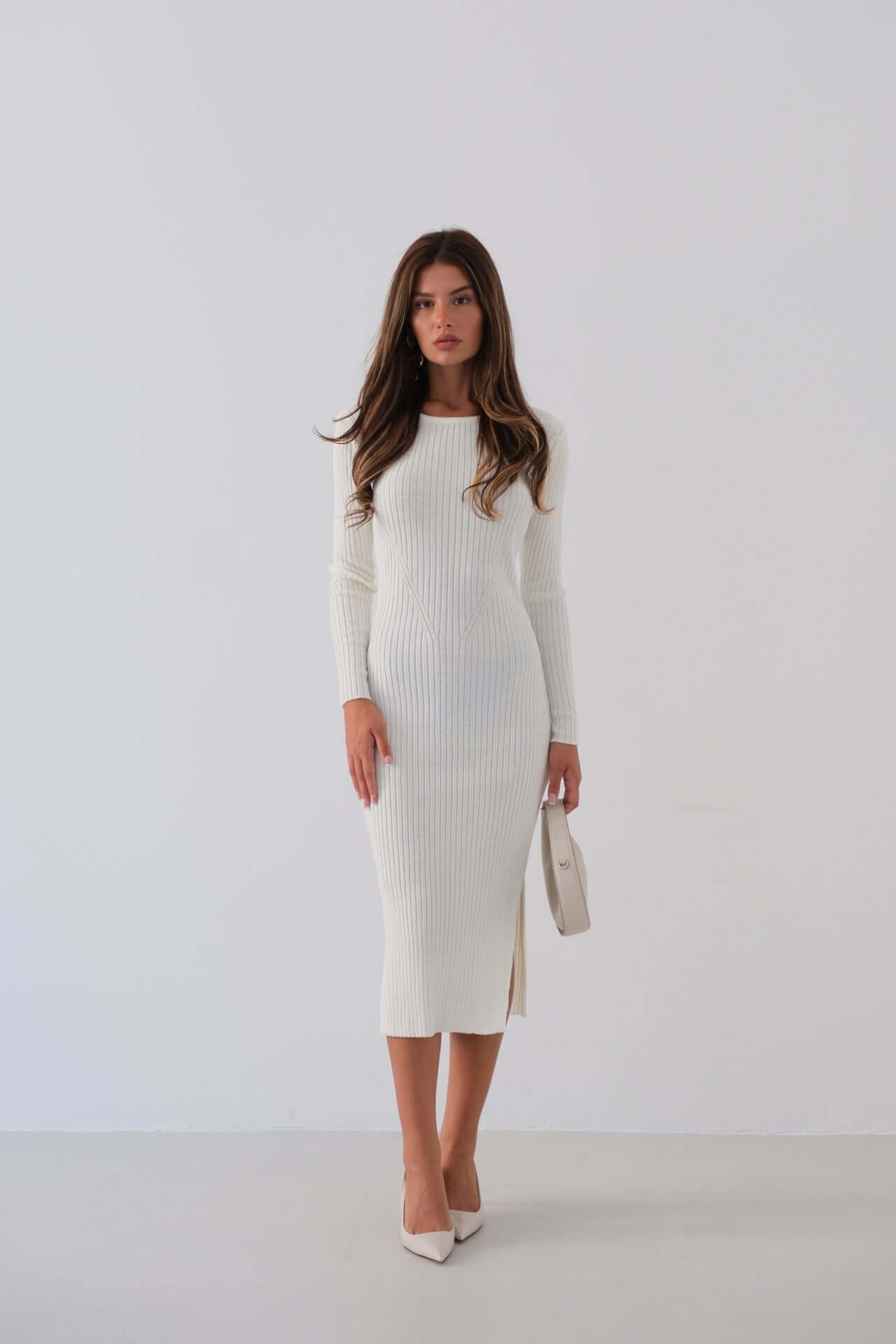 Elegant white midi ribbed dress with slit, perfect for special occasions or casual outings.